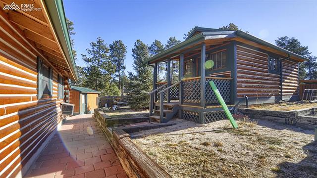 6475 Burrows Road Colorado Springs, CO 80908 - Photo 6 of 30 Back of house and side gate entry to the tiny cabin.