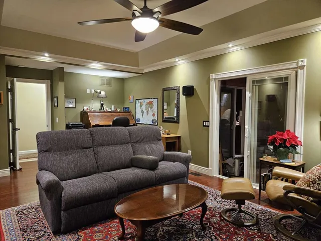 a living room with furniture and a chandelier