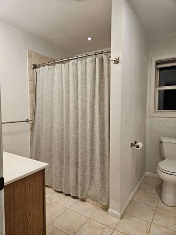 a bathroom with a shower curtain and sink