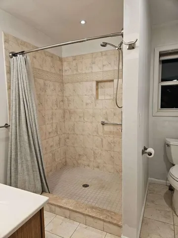 a bathroom with a shower and a toilet