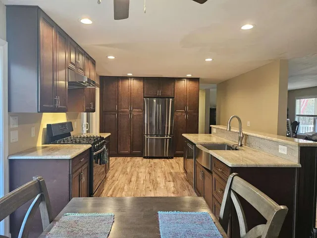 a kitchen with counter top space sink and stainless steel appliances