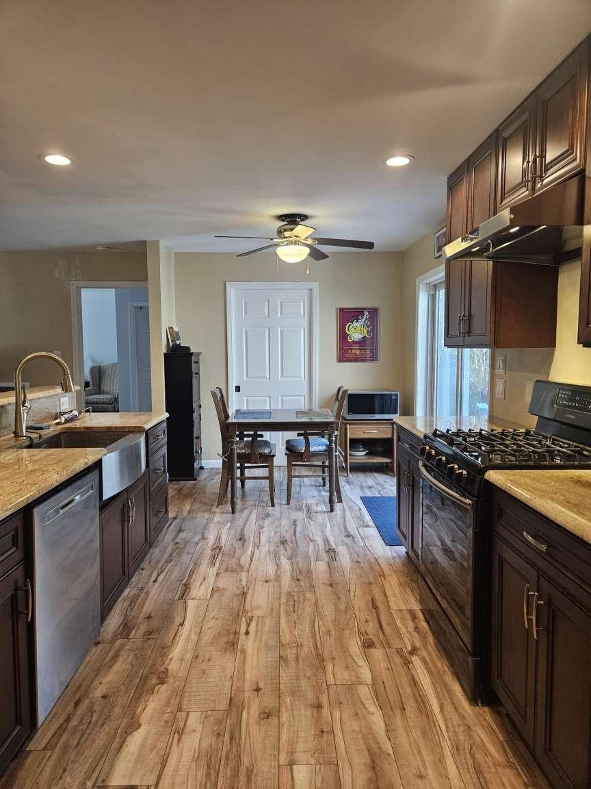 1200 Tyler Road Woodbine, NJ 08270 - Photo 4 of 29 a kitchen with stainless steel appliances granite countertop a stove and a wooden floors
