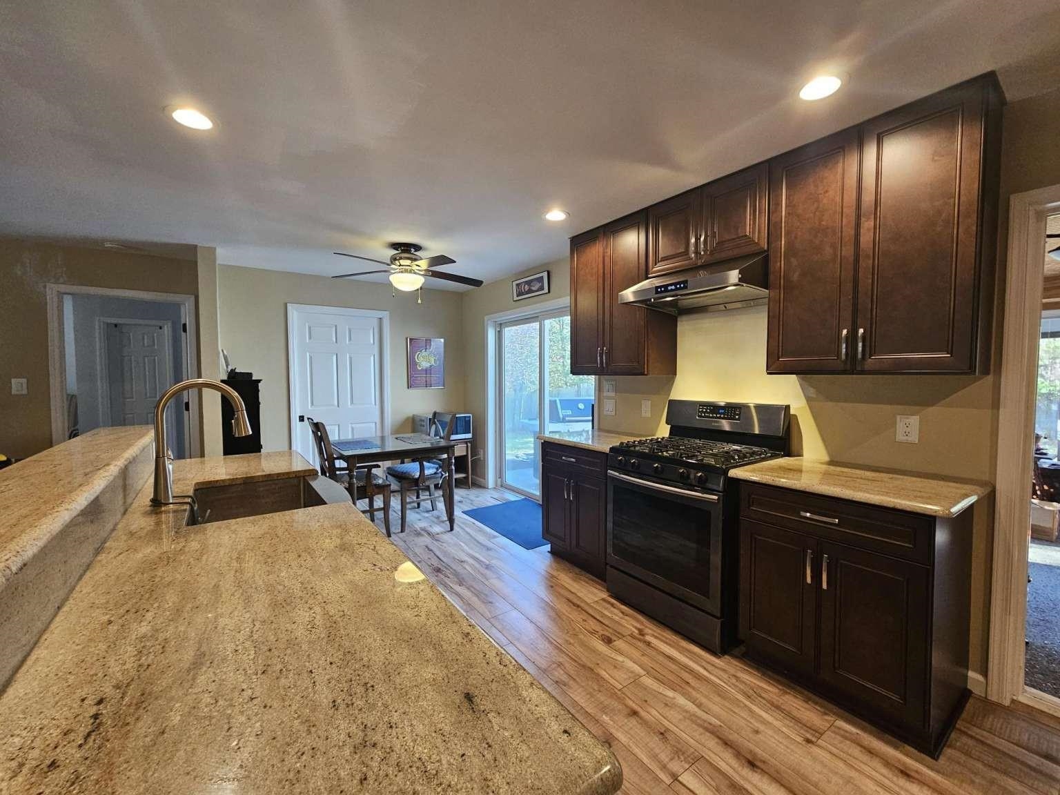 1200 Tyler Road Woodbine, NJ 08270 - Photo 7 of 29 a kitchen with stainless steel appliances granite countertop sink stove and refrigerator