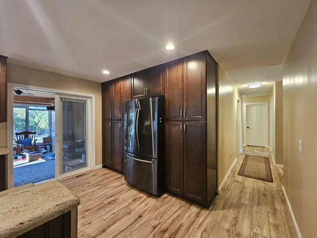 a view of kitchen island wooden floor and a refrigerator