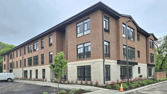 a front view of a building with a yard