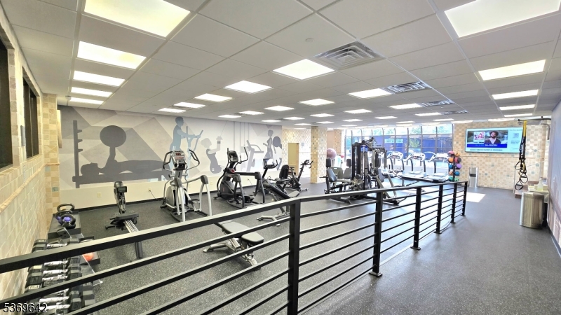 135 Fairfield Road, Unit 205 Fairfield, NJ 07004 - Photo 14 of 18 a view of a room with gym equipment