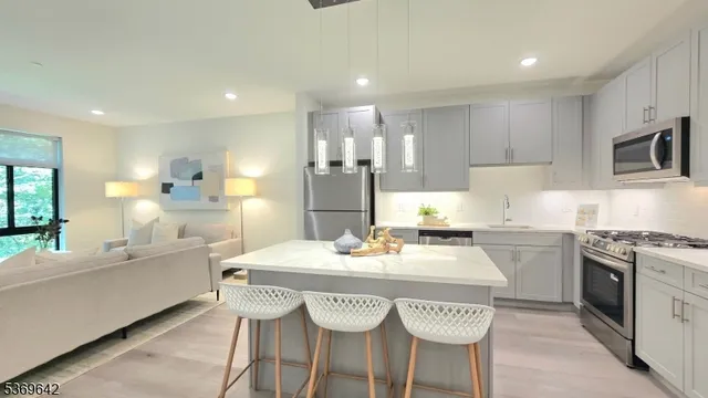 a kitchen with a dining table chairs and white cabinets