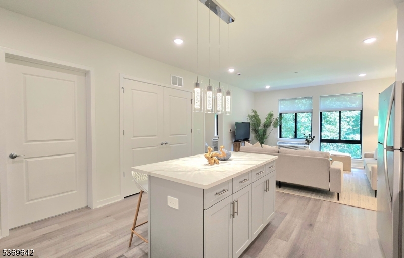 135 Fairfield Road, Unit 205 Fairfield, NJ 07004 - Photo 3 of 18 a bathroom with a sink a mirror and a bathtub