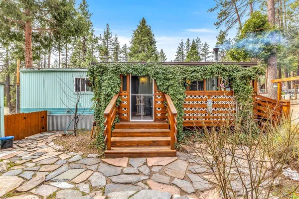 a view of a backyard with wooden fence