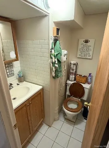 a bathroom with a sink toilet and mirror