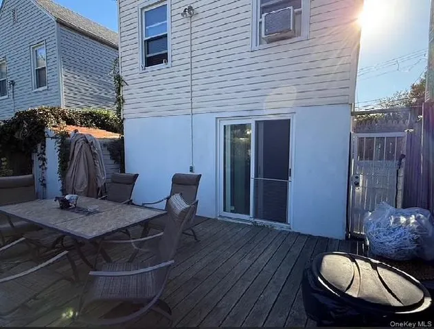 a backyard of a house with table and chairs