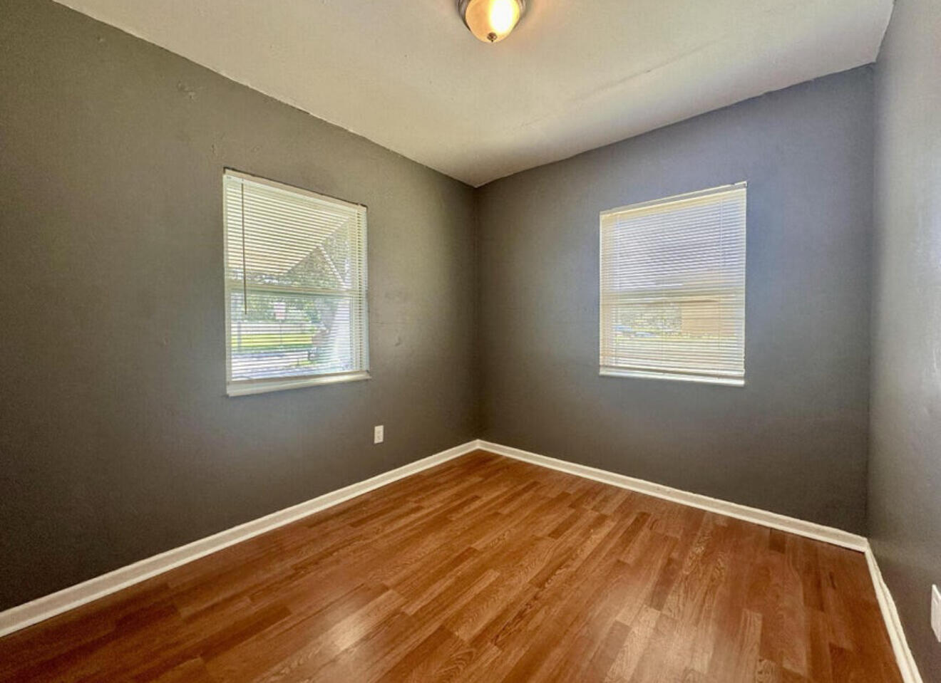 24 Southwest 10th Avenue Delray Beach, FL 33444 - Photo 15 of 25 a view of an empty room with wooden floor and a window