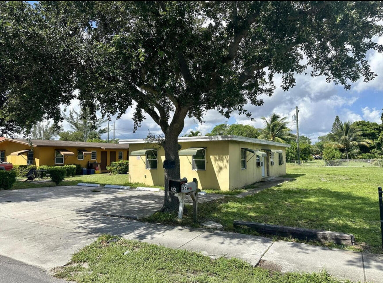 24 Southwest 10th Avenue Delray Beach, FL 33444 - Photo 2 of 25 front view of a house with a yard