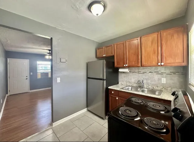 a kitchen with a stove and a refrigerator