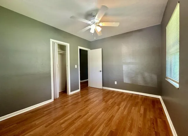 wooden floor in an empty room with a window