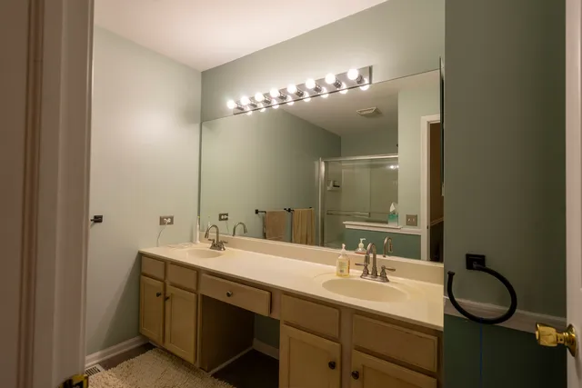a bathroom with a double vanity sink and a mirror