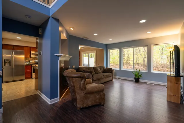 a living room with furniture and a wooden floor