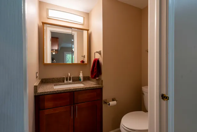a bathroom with a toilet sink and mirror