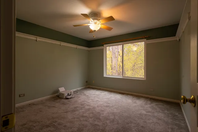 a view of a livingroom with a ceiling fan and window