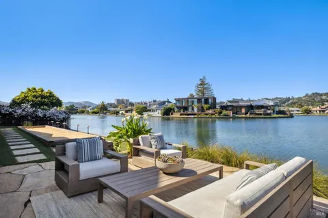 a view of a lake from balcony with seating space