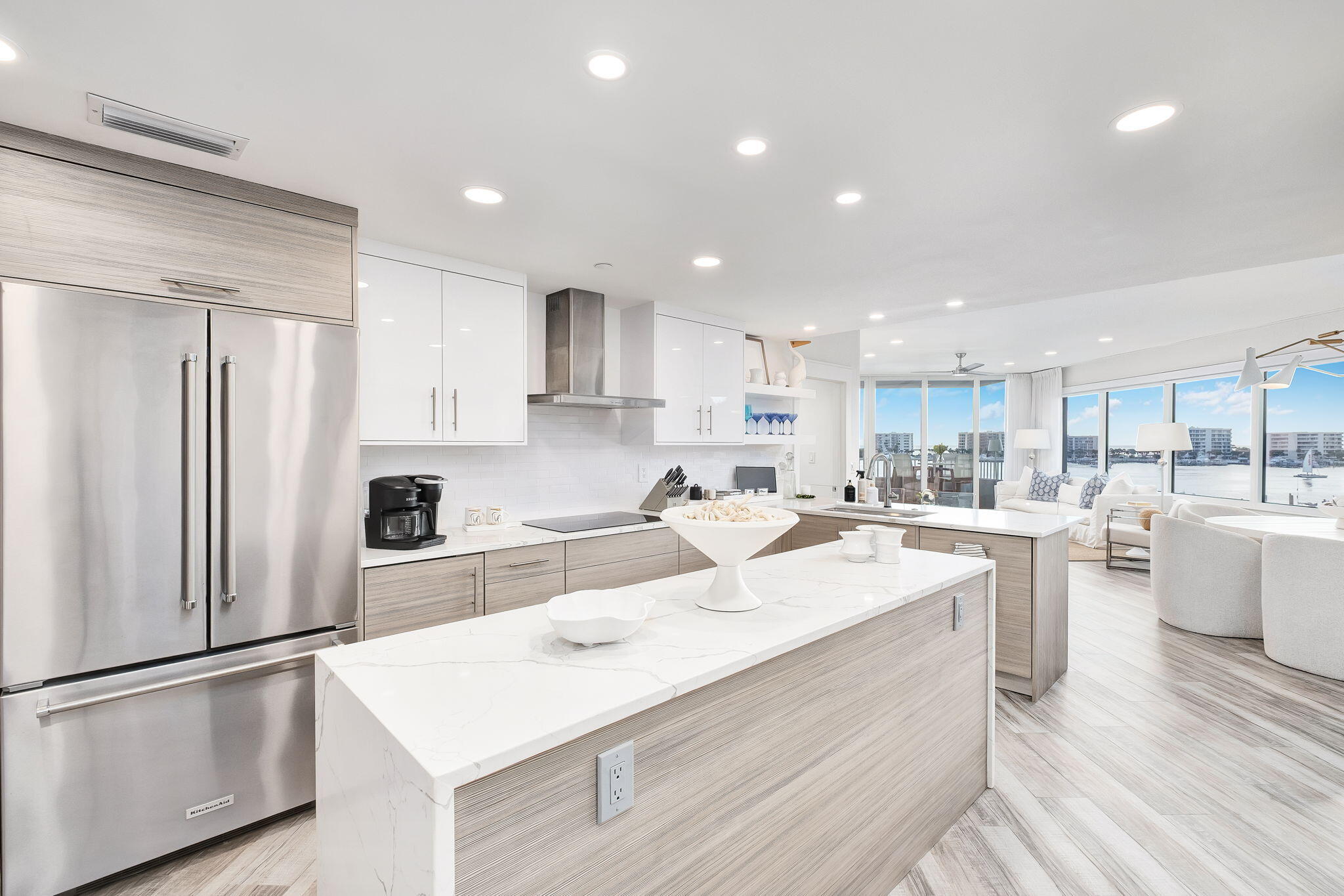 320 Harbor Boulevard, Unit A305 Destin, FL 32541 - Photo 12 of 71 a kitchen with white cabinets and stainless steel appliances