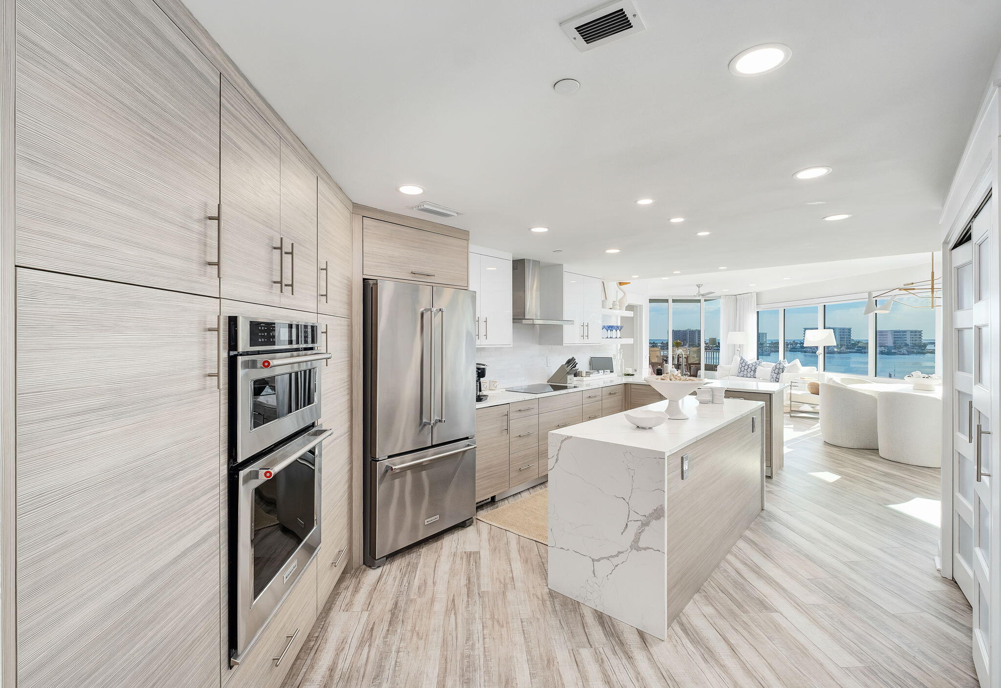 320 Harbor Boulevard, Unit A305 Destin, FL 32541 - Photo 15 of 71 a kitchen with white cabinets and stainless steel appliances