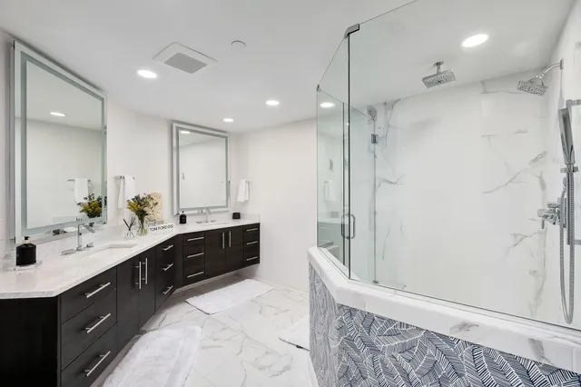 a bedroom with a bed and a ceiling fan