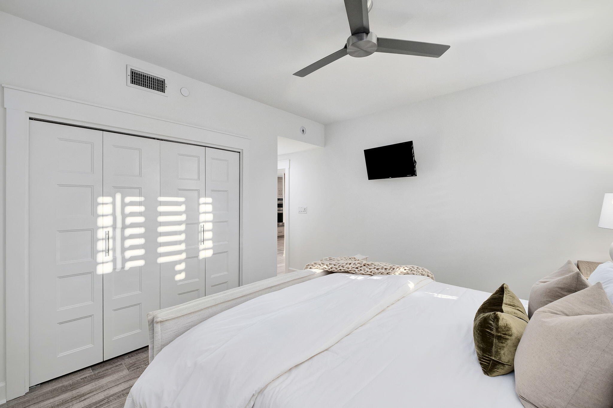 320 Harbor Boulevard, Unit A305 Destin, FL 32541 - Photo 38 of 71 a bedroom with a bed and a flat tv screen on the dresser