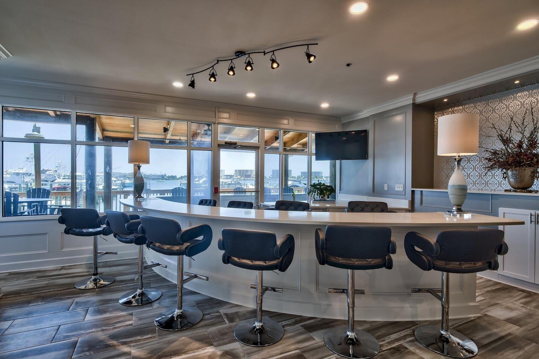 320 Harbor Boulevard, Unit A305 Destin, FL 32541 - Photo 48 of 71 a kitchen with a table and chairs