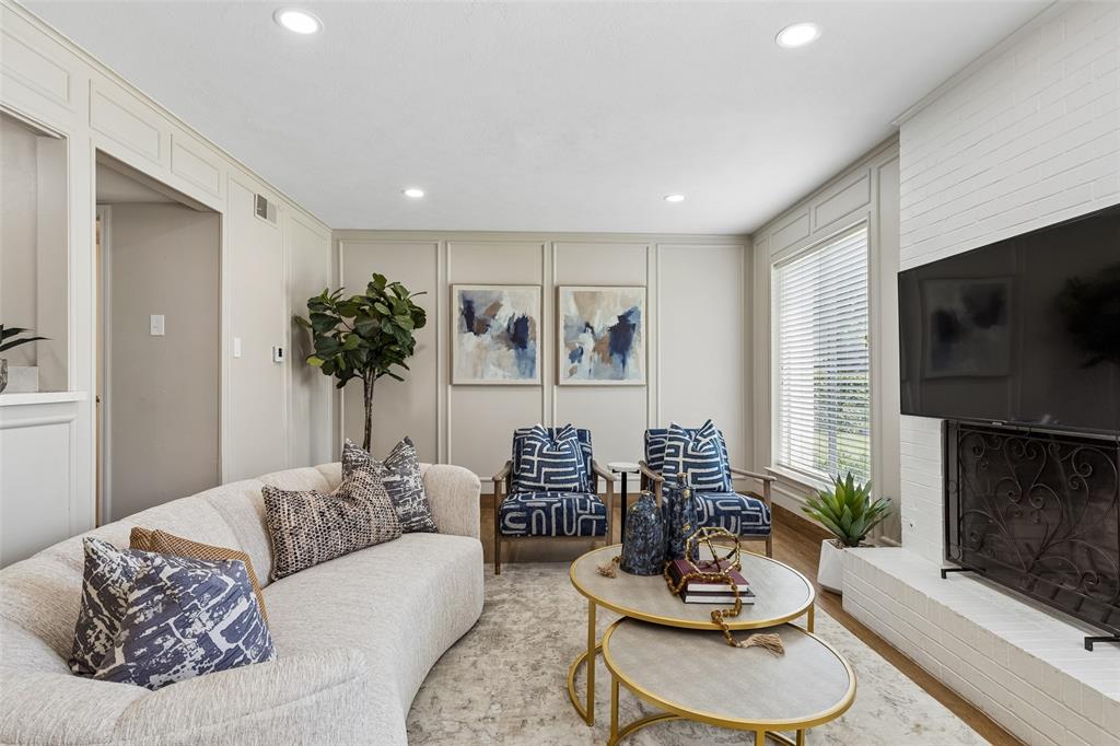 4962 Thunder Road Dallas, TX 75244 - Photo 13 of 26 Living area featuring recessed lighting, panel molding accent walls, large windows with blinds, and a white brick fireplace
