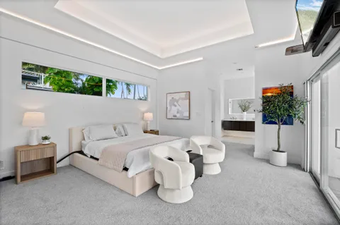 a view of a patio with couches and wooden floor