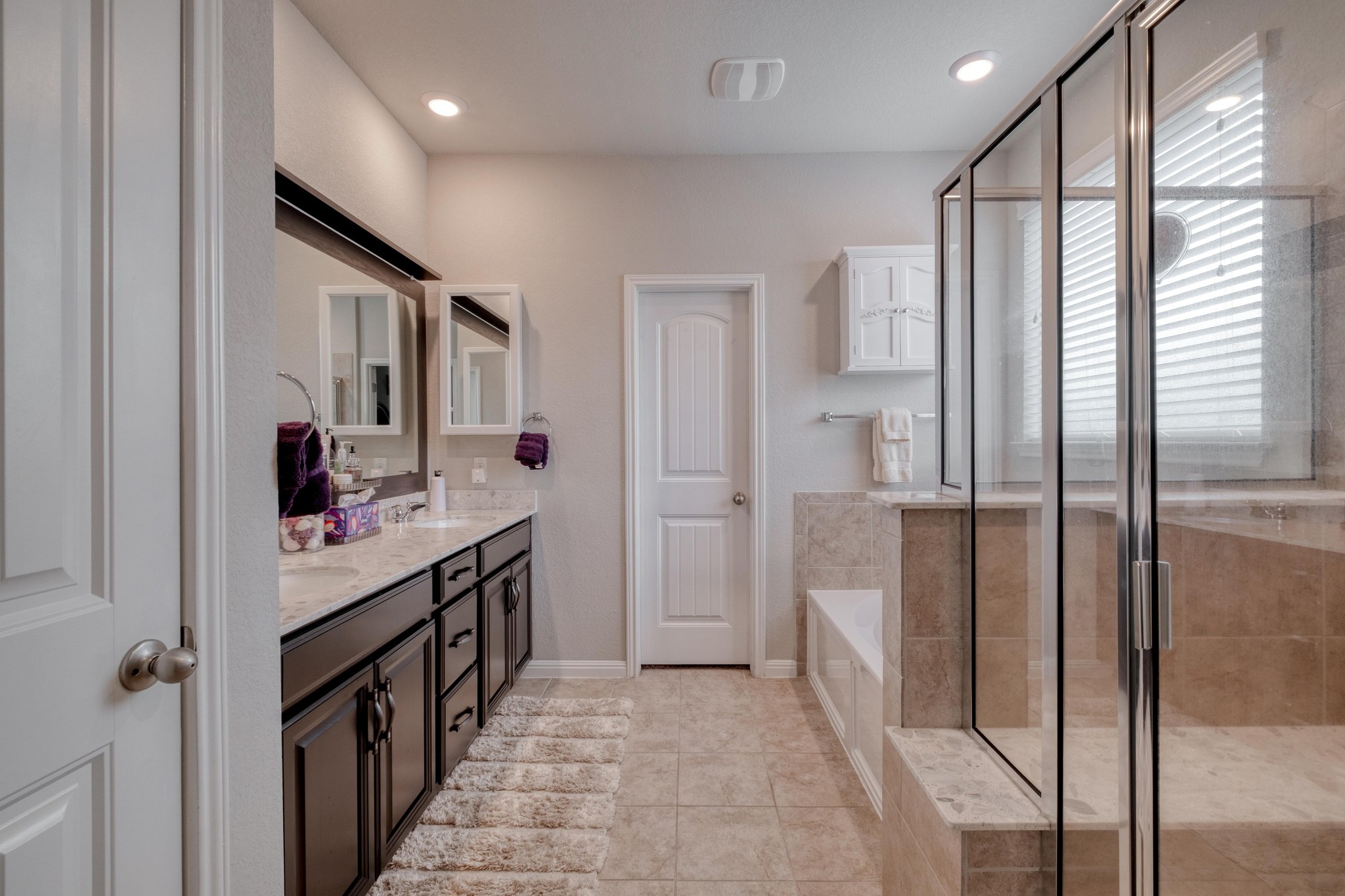 19028 Quebrada Drive Pflugerville, TX 78660 - Photo 17 of 36 a bathroom with a sink a mirror and a shower