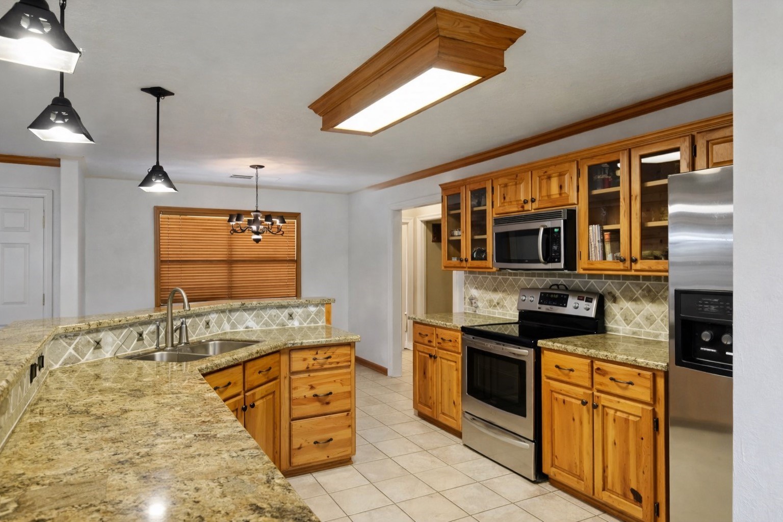 3597 Open Range Court Bryan, TX 77808 - Photo 4 of 8 a kitchen with stainless steel appliances granite countertop a stove and cabinets