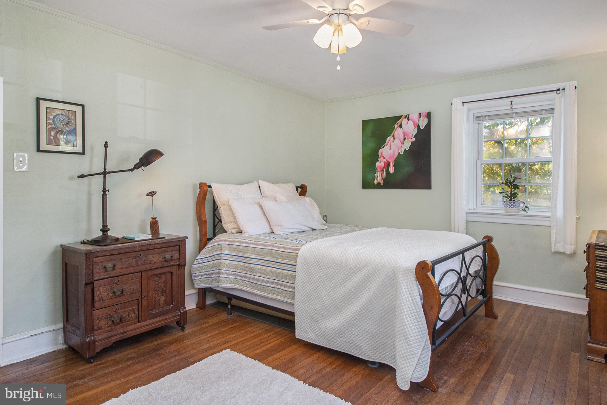 7115 Llanfair Road Upper Darby, PA 19082 - Photo 17 of 49 Primary bedroom with hardwood floors & ceiling fan