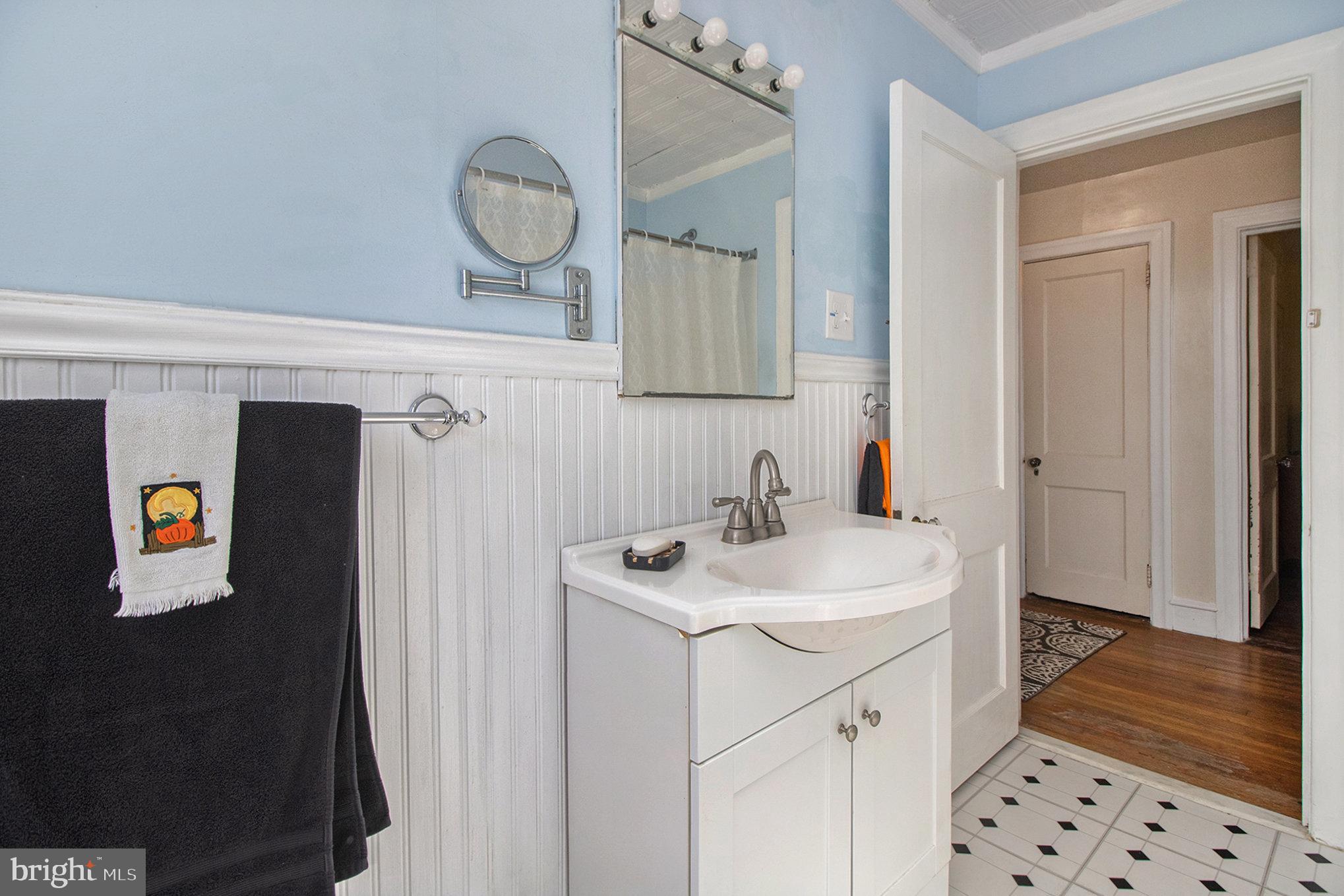 7115 Llanfair Road Upper Darby, PA 19082 - Photo 21 of 49 Main bathroom w/ wainscotting & tub /shower combo.