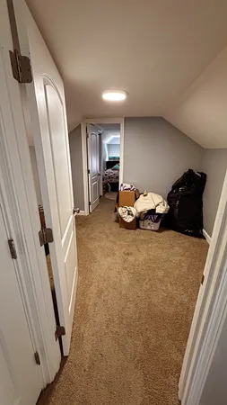 a bedroom with bed and mirror