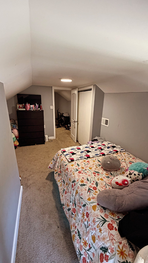 10529 South Perry Avenue Chicago, IL 60628 - Photo 16 of 17 a bedroom with bed and mirror