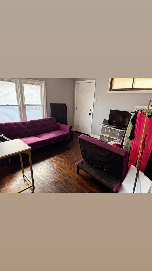 10529 South Perry Avenue Chicago, IL 60628 - Photo 7 of 17 a living room with a bed furniture and a window