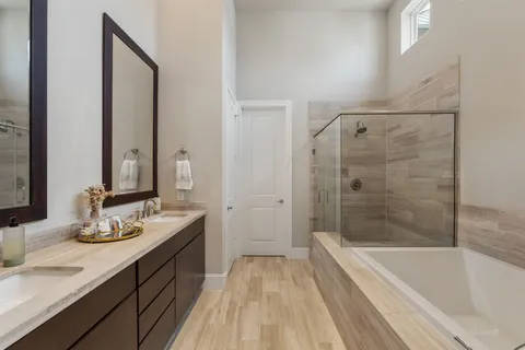 a bathroom with a tub sink and mirror