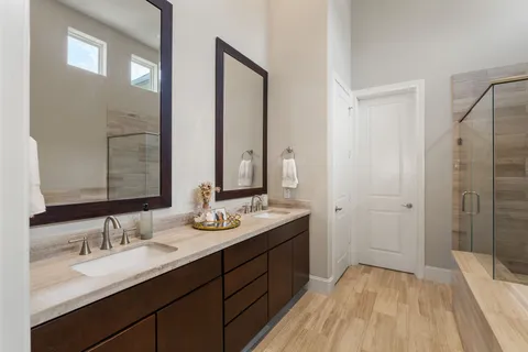 a bathroom with a double vanity sink mirror double and shower