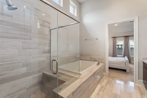 a bathroom with a tub and shower