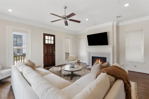 a living room with furniture a fireplace and a flat screen tv