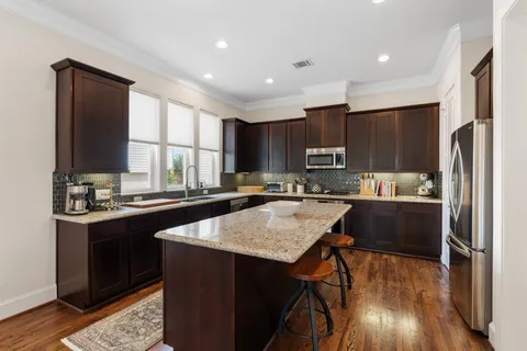 a kitchen with a refrigerator a sink a stove a microwave and cabinets