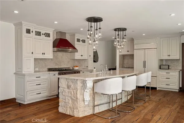 a kitchen with stainless steel appliances granite countertop a stove and a refrigerator