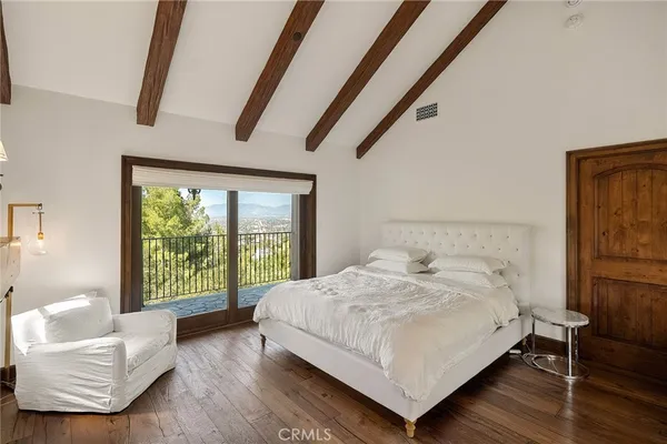 a bedroom with a bed and a large window