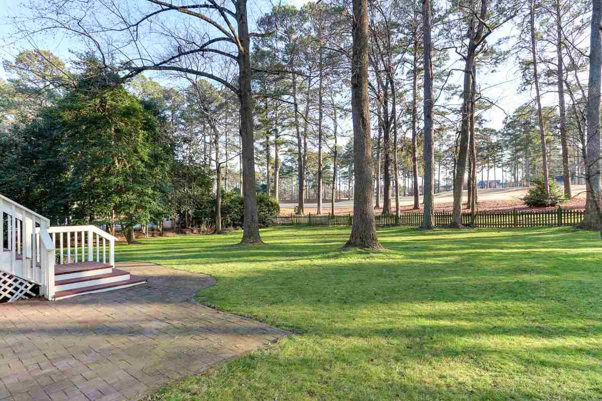 7009 North Ridge Drive Raleigh, NC 27615 - Photo 23 of 25 Backyard has paver patio for grilling and is all fenced in. Backyard