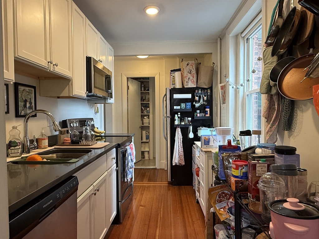 1871 Beacon Street, Unit 4 Brookline, MA 02445 - Photo 7 of 14 a kitchen with stainless steel appliances a stove a sink and a refrigerator