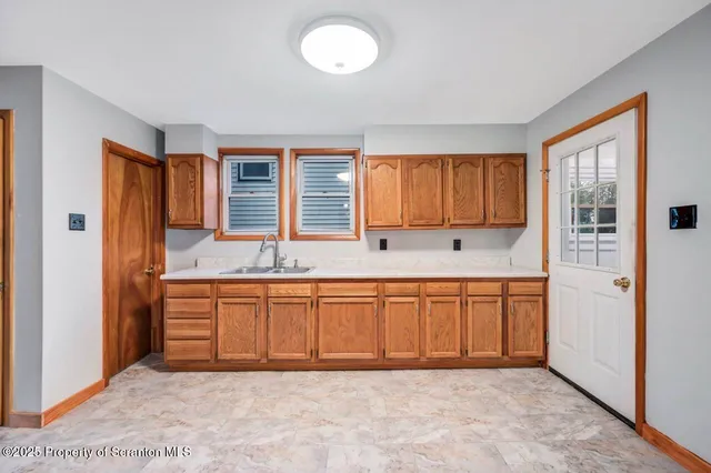 a spacious bathroom with granite countertop a sink and a bathtub