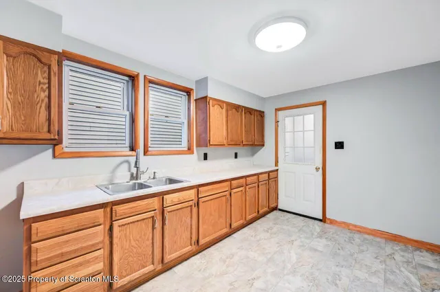 a view of a kitchen with a sink dishwasher and a fireplace