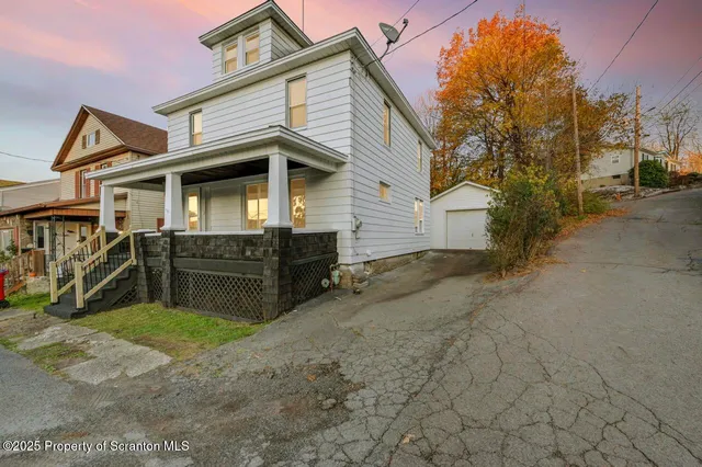 a view of a house with a yard and garage